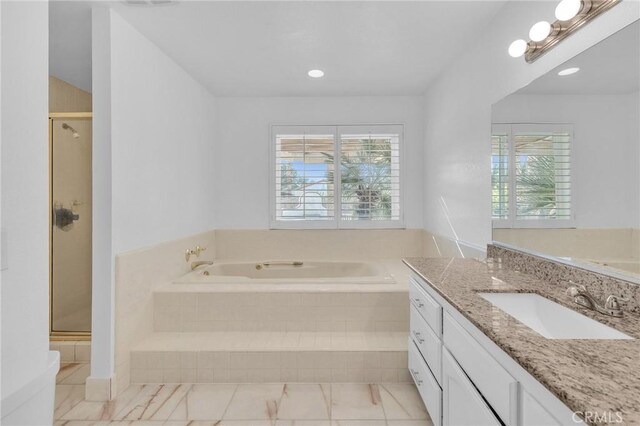 bathroom with tile patterned floors, separate shower and tub, and vanity