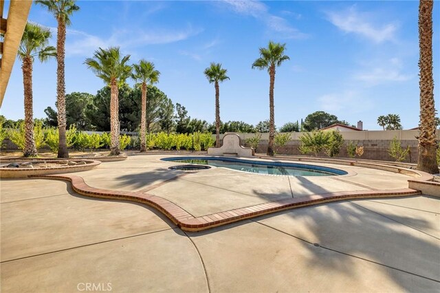 view of swimming pool with a patio area and an in ground hot tub