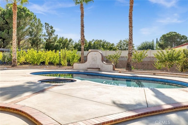 view of swimming pool with an in ground hot tub and a patio