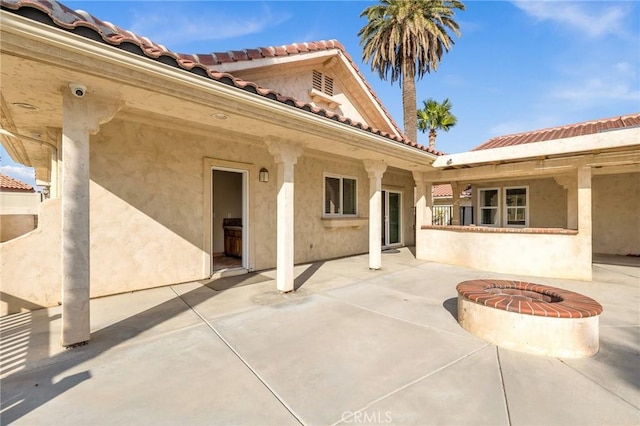 view of patio / terrace featuring an outdoor fire pit