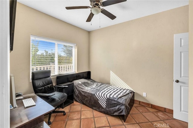 bedroom with ceiling fan and light tile patterned flooring