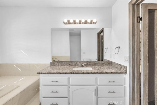 bathroom featuring vanity and a bath