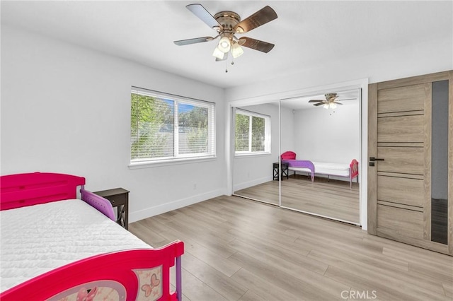 bedroom with ceiling fan, a closet, and light wood-type flooring