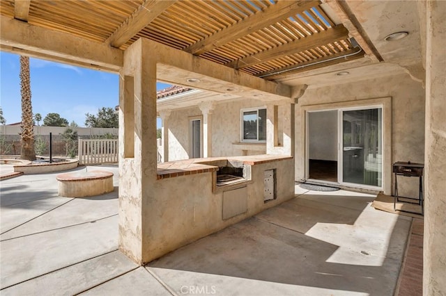 view of patio / terrace featuring a pergola and exterior kitchen