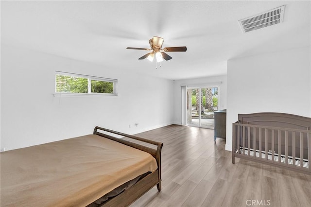 bedroom with ceiling fan and light hardwood / wood-style flooring