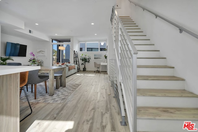 staircase with hardwood / wood-style floors