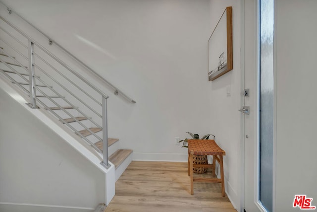 stairs featuring hardwood / wood-style flooring