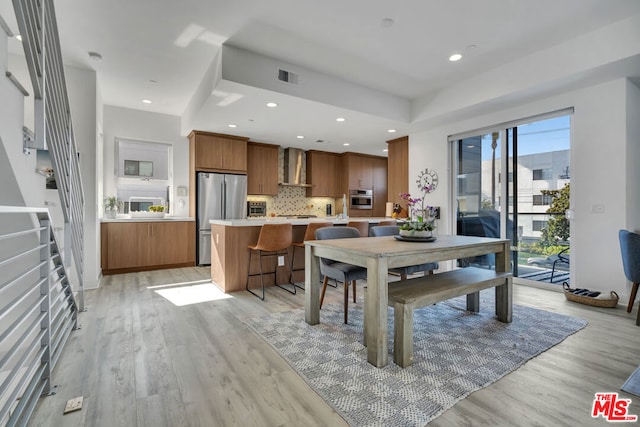 dining space with light hardwood / wood-style floors