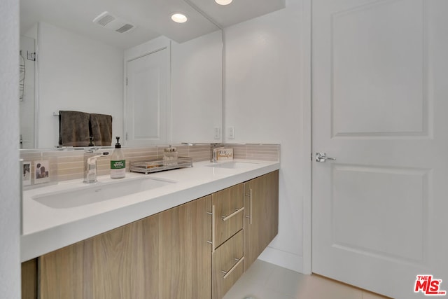 bathroom with tile patterned flooring and vanity