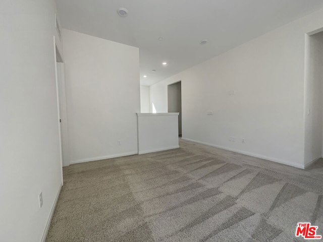 empty room featuring light carpet