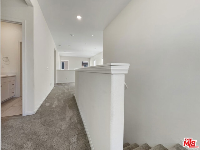 hallway with carpet floors