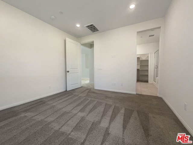 unfurnished room featuring light carpet