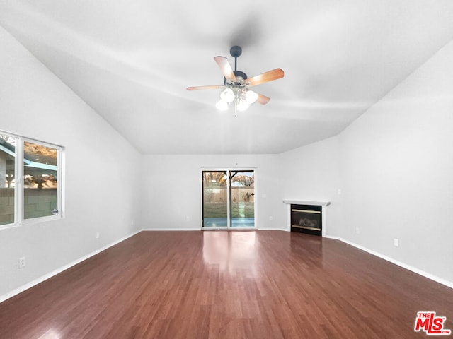 unfurnished living room featuring ceiling fan and dark wood-type flooring