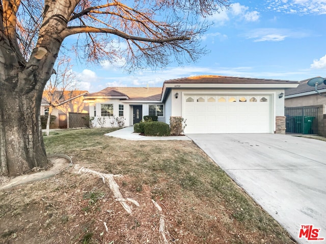 ranch-style home with a garage and a front yard