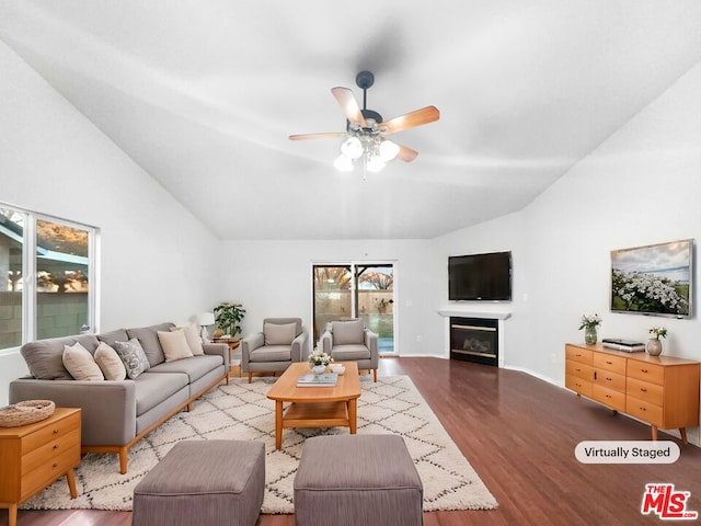 living room featuring vaulted ceiling, light hardwood / wood-style flooring, and ceiling fan