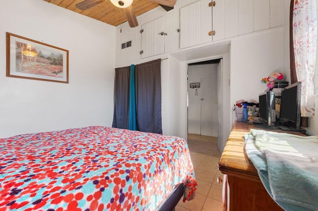 bedroom featuring beam ceiling, ceiling fan, a high ceiling, light tile patterned floors, and wood ceiling