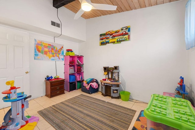 rec room featuring vaulted ceiling with beams, ceiling fan, light tile patterned floors, and wooden ceiling