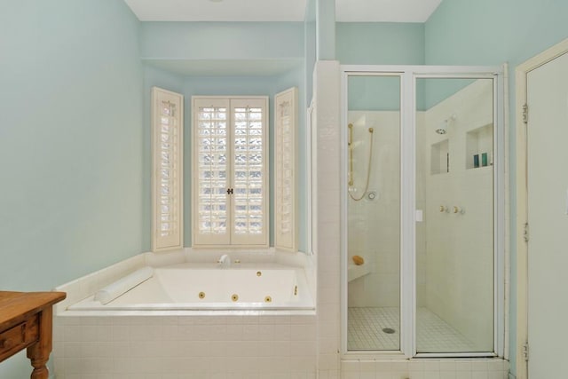 bathroom featuring separate shower and tub