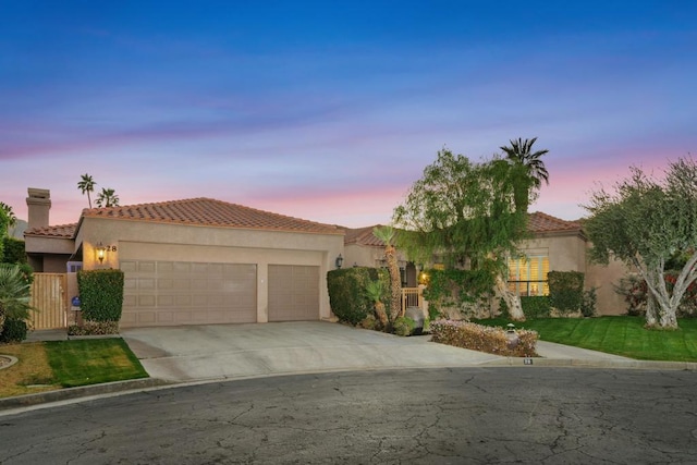 mediterranean / spanish home featuring a garage