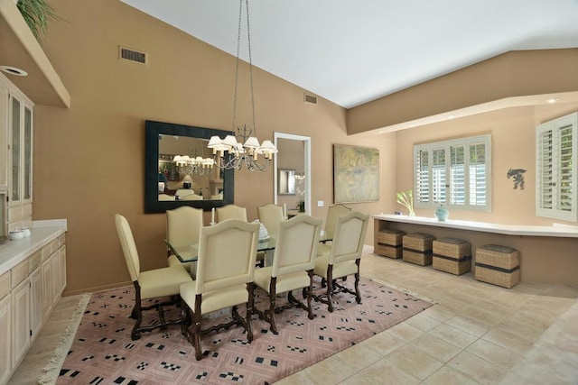 dining room with light tile patterned floors, a chandelier, and high vaulted ceiling