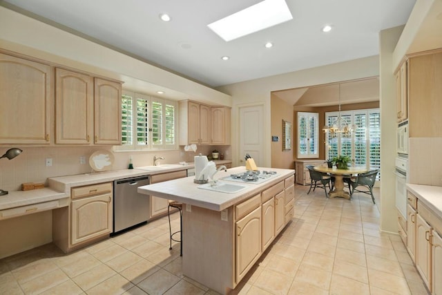 kitchen featuring pendant lighting, light brown cabinets, white appliances, and a skylight