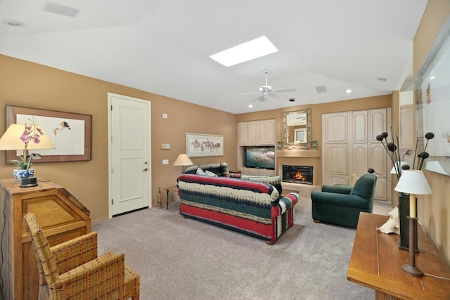 carpeted bedroom with ceiling fan and vaulted ceiling with skylight