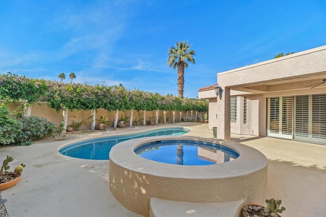 view of swimming pool with a patio area and an in ground hot tub