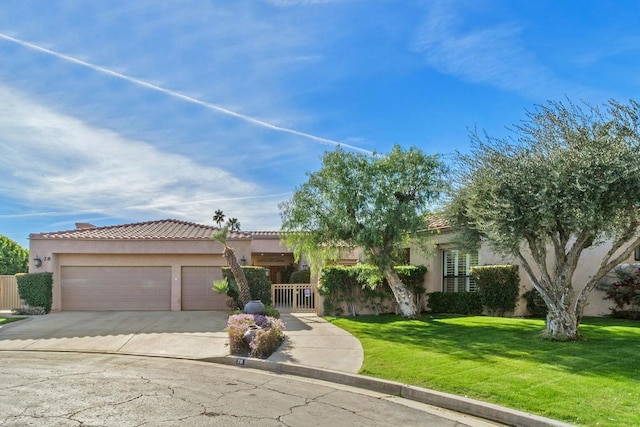 view of front of home featuring a garage and a front lawn