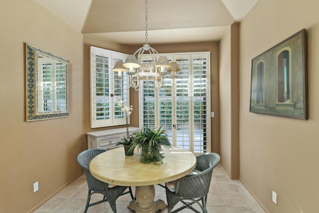 dining room featuring light tile patterned flooring, lofted ceiling, and an inviting chandelier