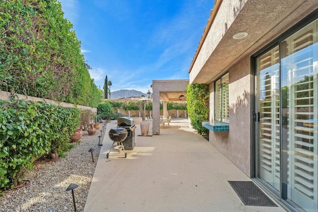 view of patio featuring a mountain view and ceiling fan