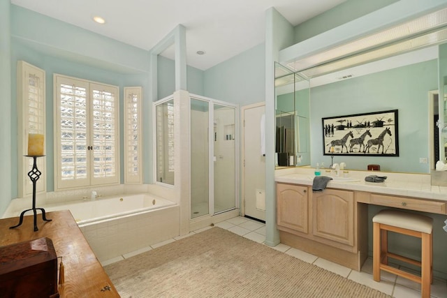 bathroom featuring tile patterned floors, vanity, and shower with separate bathtub