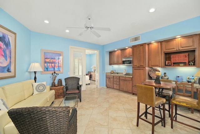 kitchen featuring light tile patterned floors, ceiling fan, and sink