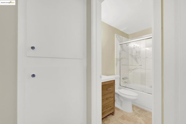 bathroom featuring enclosed tub / shower combo and toilet