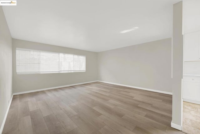 spare room featuring light hardwood / wood-style flooring