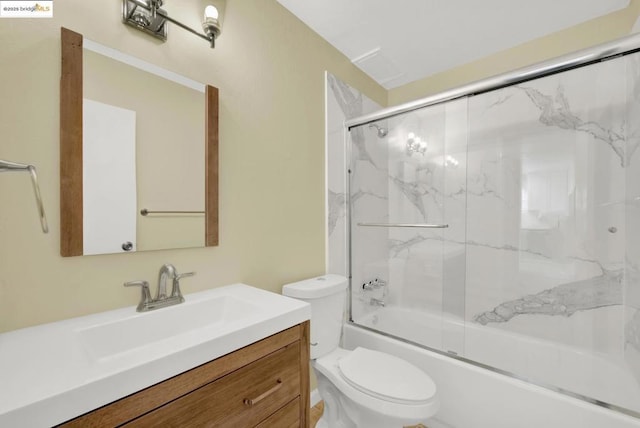 full bathroom with shower / bath combination with glass door, vanity, and toilet