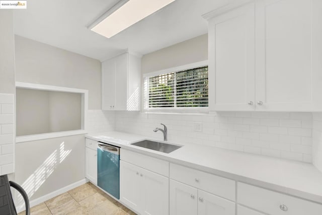 kitchen featuring white cabinets, decorative backsplash, stainless steel dishwasher, and sink