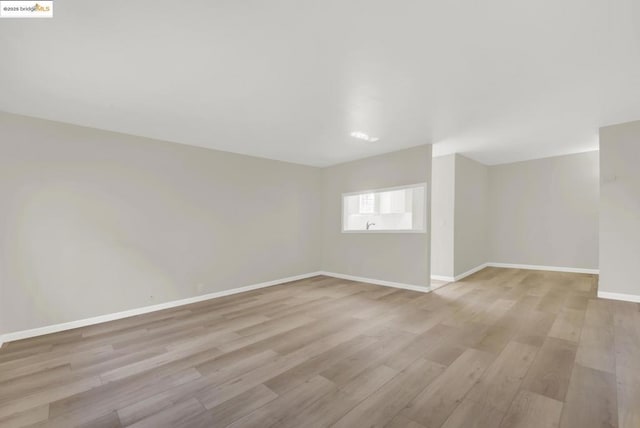 spare room featuring light hardwood / wood-style flooring