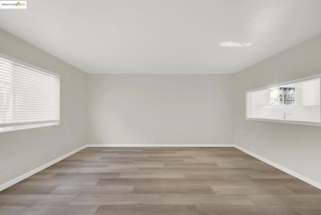 spare room with light hardwood / wood-style floors