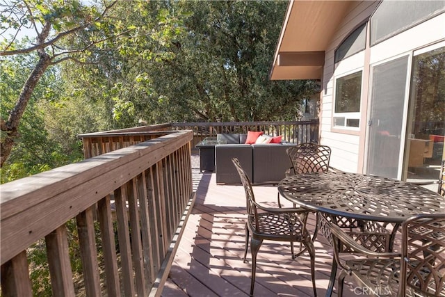 wooden terrace with an outdoor hangout area