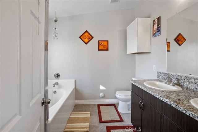 bathroom featuring vanity, tiled bath, tile patterned floors, and toilet