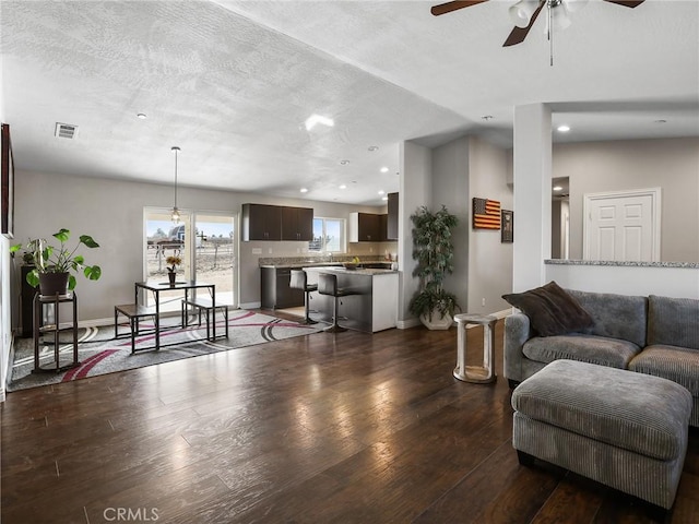 7755 7th St, Phelan, CA 92371 - living area featuring a ceiling fan, dark wood-style flooring, recessed lighting, and baseboards