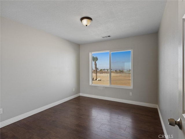 7755 7th St, Phelan, CA 92371 - empty room featuring dark wood-style floors, baseboards, and a textured ceiling