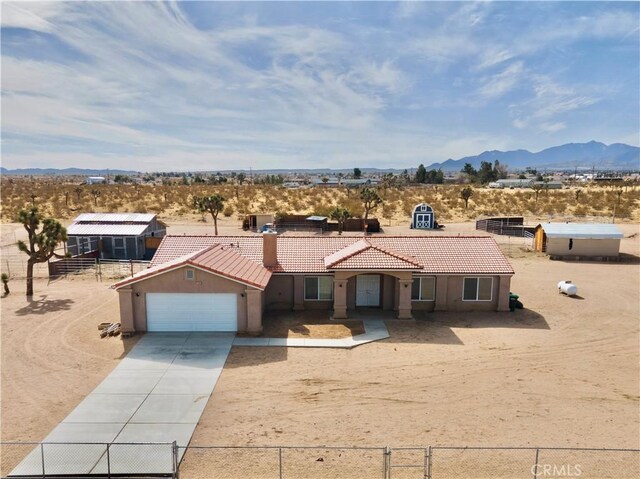 single story home with a mountain view and a garage