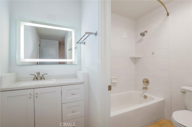 full bathroom featuring tile patterned flooring, vanity, toilet, and tiled shower / bath