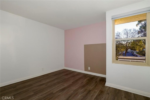 spare room featuring dark hardwood / wood-style floors