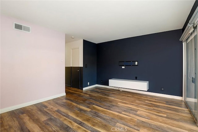 empty room with dark wood-type flooring