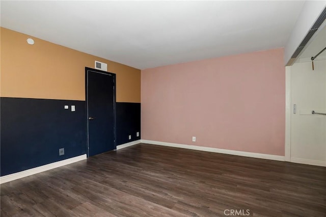 spare room with dark hardwood / wood-style flooring