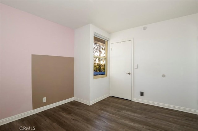 spare room with dark wood-type flooring