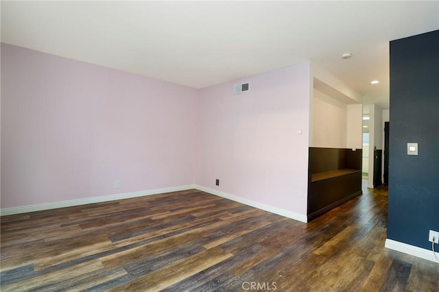 unfurnished room featuring dark hardwood / wood-style floors