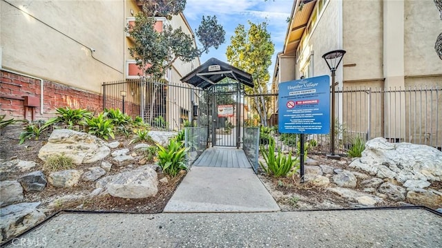 view of community with a gate and fence